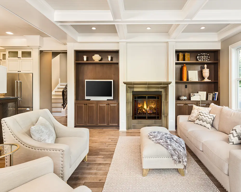 Elegant living room with built-in cabinetry, fireplace, and coffered ceiling design.