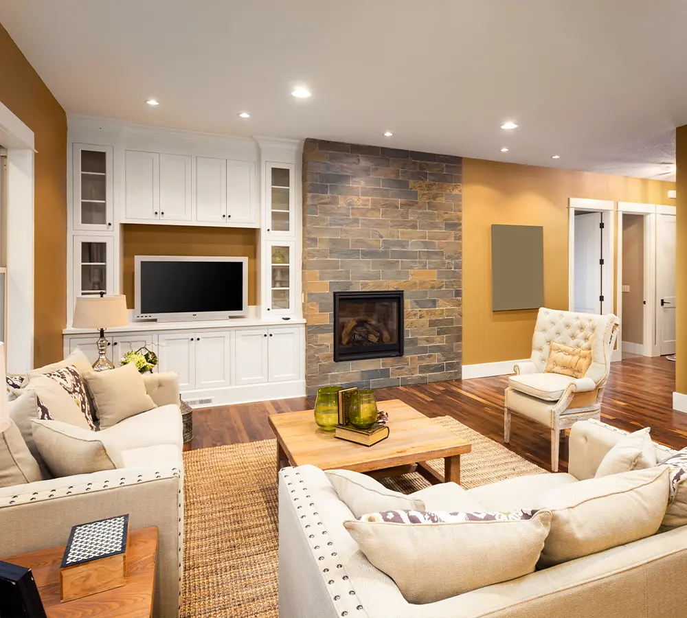 Modern living room with stone fireplace, built-in shelves, and stylish furniture for cozy and inviting interiors.