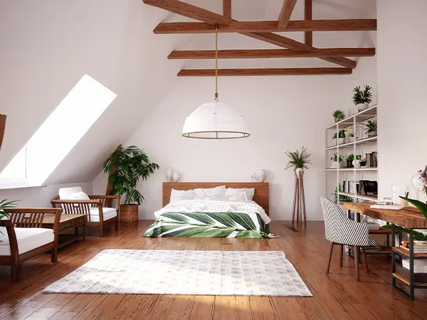 Modern-attic-bedroom-with-exposed-wooden-beams,-lush-greenery,-and-cozy-furnishings,-creating-a-serene-and-stylish-retreat