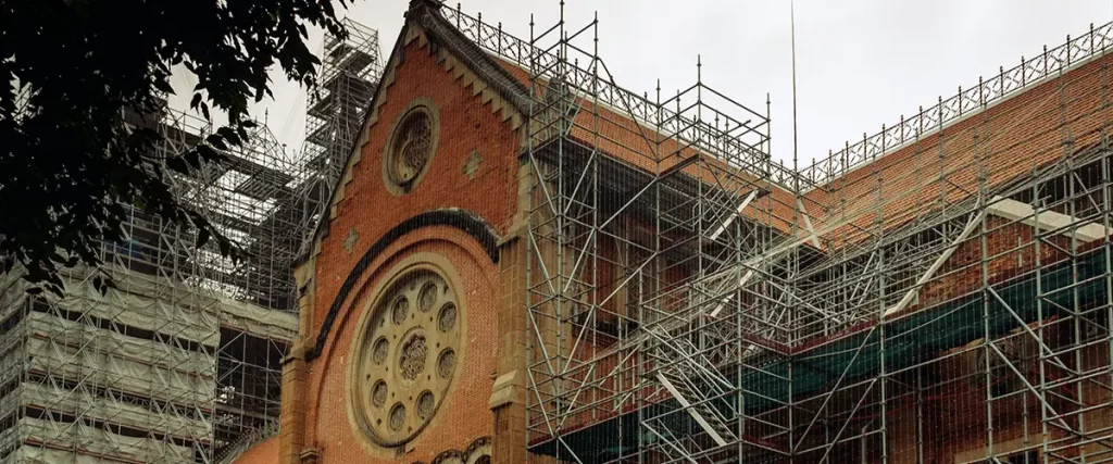 Ornate heritage building roofline with full scaffolding setup