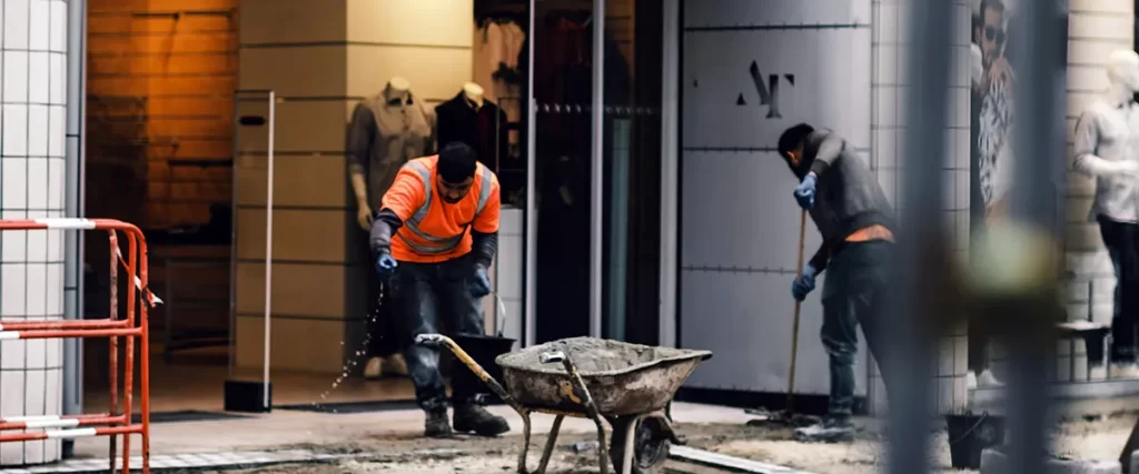 Crew performing exterior renovation in a commercial shopping area
