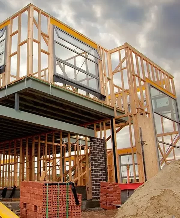 New residential construction with wood framing and brick piles, demonstrating the quality build process of a custom home builder in Perth Amboy, NJ.