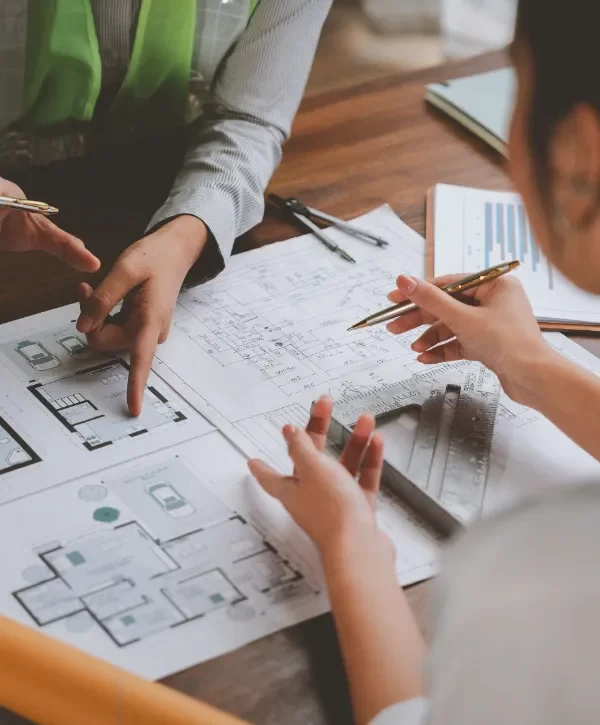 people reviewing architectural plans for a commercial design build project